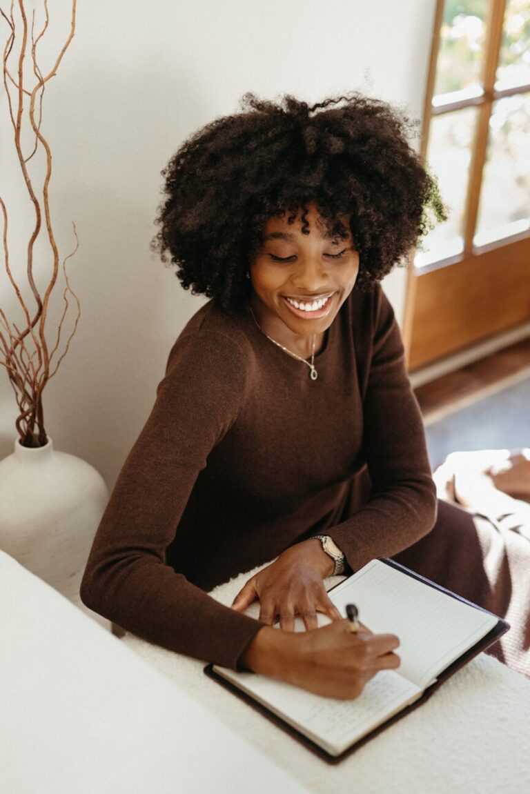 woman smiling journaling 865x1296