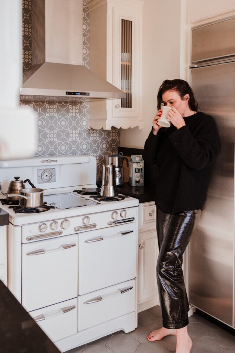 woman drinking coffee in kitchen 865x1298