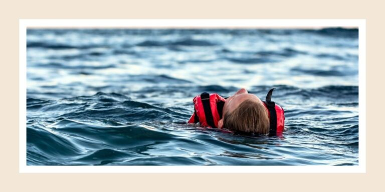 child swimming in lake